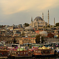 Rustem Pasha and Suleymaniye Mosques at sunrise with tour boats 